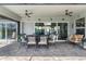 Cozy patio with outdoor seating, ceiling fans, and seamless access to indoor living spaces at 571 Port Bendres Dr, Punta Gorda, FL 33950