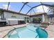 Relaxing backyard pool with a lanai, outdoor kitchen, and clear blue water in Florida at 571 Port Bendres Dr, Punta Gorda, FL 33950