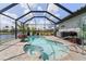 Gorgeous in-ground pool and spa inside screened lanai for year-round enjoyment in an outdoor setting at 571 Port Bendres Dr, Punta Gorda, FL 33950