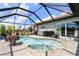 Sparkling pool and spa surrounded by a screened enclosure, offering privacy and sunshine at 571 Port Bendres Dr, Punta Gorda, FL 33950