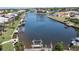 Stunning aerial shot showcasing a canal-front property with boat docks and tropical landscaping at 584 Toulouse Dr, Punta Gorda, FL 33950