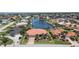 Aerial view showcasing tile roof, waterfront location, screened lanai, and mature landscaping at 584 Toulouse Dr, Punta Gorda, FL 33950