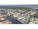 Aerial view of a charming waterfront neighborhood with canals, lush greenery, and a clear blue waterway at 584 Toulouse Dr, Punta Gorda, FL 33950
