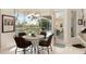 Cozy dining area with a view of the screened lanai and pool area at 584 Toulouse Dr, Punta Gorda, FL 33950