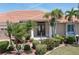 Inviting front entrance featuring a tile roof, mature palms, and a well-maintained lawn at 584 Toulouse Dr, Punta Gorda, FL 33950