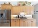 Bright kitchen featuring maple cabinetry, stainless steel appliances, and granite countertops at 584 Toulouse Dr, Punta Gorda, FL 33950