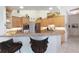 Eat-in kitchen with tan cabinetry, granite counters, stainless appliances, and seating at the peninsula counter at 584 Toulouse Dr, Punta Gorda, FL 33950