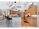 Open-concept eat-in kitchen featuring maple cabinetry, granite counters, stainless appliances, and peninsula seating at 584 Toulouse Dr, Punta Gorda, FL 33950