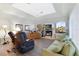 Comfortable living room with plush seating, built-in entertainment center, and views from arched windows at 584 Toulouse Dr, Punta Gorda, FL 33950
