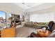Comfortable living room featuring wood floors, a built-in entertainment center, and water views at 584 Toulouse Dr, Punta Gorda, FL 33950