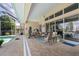 Screened-in patio featuring outdoor seating and view of pool and tropical landscape at 584 Toulouse Dr, Punta Gorda, FL 33950