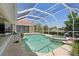 Beautiful pool and jacuzzi with screened in patio with seating and tropical views at 584 Toulouse Dr, Punta Gorda, FL 33950