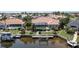 Aerial view showcasing a screened pool, private dock, and scenic canal access behind the home at 584 Toulouse Dr, Punta Gorda, FL 33950