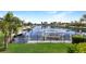 Scenic waterfront view with a private boat dock, lush landscaping, and clear water at 584 Toulouse Dr, Punta Gorda, FL 33950