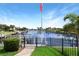 Gorgeous waterfront views of calm canal with mature landscaping and blue skies at 584 Toulouse Dr, Punta Gorda, FL 33950