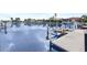 Scenic waterfront view with boats docked along a tranquil canal lined with palm trees and beautiful homes at 584 Toulouse Dr, Punta Gorda, FL 33950