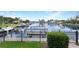Peaceful canal view with boats docked, framed by a wrought iron fence and lush green landscaping at 584 Toulouse Dr, Punta Gorda, FL 33950