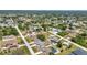 Nice aerial view of a residential neighborhood showcasing neat properties, tree coverage, and paved roads at 6344 Hera St, Englewood, FL 34224