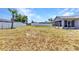 Expansive backyard with a white fence and covered patio at 6344 Hera St, Englewood, FL 34224