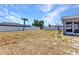 Large backyard with a white fence and covered patio at 6344 Hera St, Englewood, FL 34224