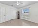 Clean bedroom with neutral tile flooring, ceiling fan, and a window for natural light at 6344 Hera St, Englewood, FL 34224