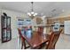Well-lit dining area featuring tile flooring, a wooden table, and an adjacent kitchen, perfect for Gathering meals at 6344 Hera St, Englewood, FL 34224