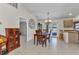 Well-lit dining room featuring a chandelier, tile flooring, and a wooden table with chairs at 6344 Hera St, Englewood, FL 34224