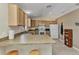An open kitchen featuring neutral countertops, tile flooring and standard appliances at 6344 Hera St, Englewood, FL 34224