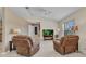 Comfortable living room featuring tile flooring, a ceiling fan, and cozy seating around an entertainment center at 6344 Hera St, Englewood, FL 34224