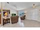 Bright living room with tile flooring, neutral walls, and comfortable seating by a large window at 6344 Hera St, Englewood, FL 34224