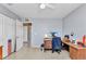 A home office featuring tile floors, a desk, and a view of the backyard at 6344 Hera St, Englewood, FL 34224