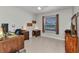 A home office with natural lighting, tile floors, a desk, and dark wood furniture at 6344 Hera St, Englewood, FL 34224