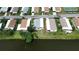 Overhead view of a waterfront property, highlighting the home's proximity to a scenic pond at 749 Watersedge St, Englewood, FL 34223