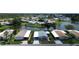 Aerial view of homes surrounding a tranquil pond, nestled in a lush, green community at 749 Watersedge St, Englewood, FL 34223