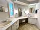 Bright bathroom with dual sinks, vanity area, and a large mirror reflecting natural light at 749 Watersedge St, Englewood, FL 34223