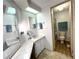 Bathroom featuring ample counter space, a skylight, and an adjacent toilet and shower area at 749 Watersedge St, Englewood, FL 34223