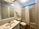 Bathroom features a tub/shower combination with neutral accents and a classic vanity at 749 Watersedge St, Englewood, FL 34223