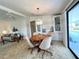 Open-concept dining area with seating for four that connects the kitchen to the living room at 749 Watersedge St, Englewood, FL 34223