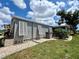 Home's exterior showcases well-kept landscaping, shutters, and a clean, modern design at 749 Watersedge St, Englewood, FL 34223