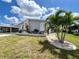 Beautiful home with a manicured lawn, decorative plants, and inviting curb appeal at 749 Watersedge St, Englewood, FL 34223