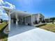 Charming exterior with a convenient carport, complemented by well-maintained landscaping at 749 Watersedge St, Englewood, FL 34223