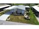 Charming home with a well-maintained lawn, stone-lined garden, and a convenient covered parking area at 749 Watersedge St, Englewood, FL 34223