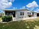 Inviting single-story home with landscaping, covered front porch and well manicured lawn at 749 Watersedge St, Englewood, FL 34223