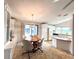 Bright kitchen features a dining area, breakfast bar, white cabinetry, and modern appliances for a functional cooking space at 749 Watersedge St, Englewood, FL 34223