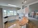 Bright kitchen has white appliances and cabinets, with a breakfast bar opening to the living space at 749 Watersedge St, Englewood, FL 34223
