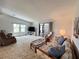Inviting living room featuring a comfortable seating arrangement and sliding doors that lead to an enclosed outdoor space at 749 Watersedge St, Englewood, FL 34223