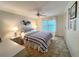 Comfortable main bedroom with nautical decor, a ceiling fan, and a window at 749 Watersedge St, Englewood, FL 34223
