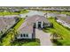 An aerial view of a beautiful single-Gathering home with a lake view in a gated community at 8968 Artisan Way, Sarasota, FL 34240