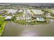 Beautiful aerial view of the community showcasing the lake, pool, clubhouse, and the well-maintained surroundings at 8968 Artisan Way, Sarasota, FL 34240
