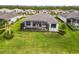 An aerial view of the back of a single-Gathering home with a screened-in pool and a large backyard at 8968 Artisan Way, Sarasota, FL 34240
